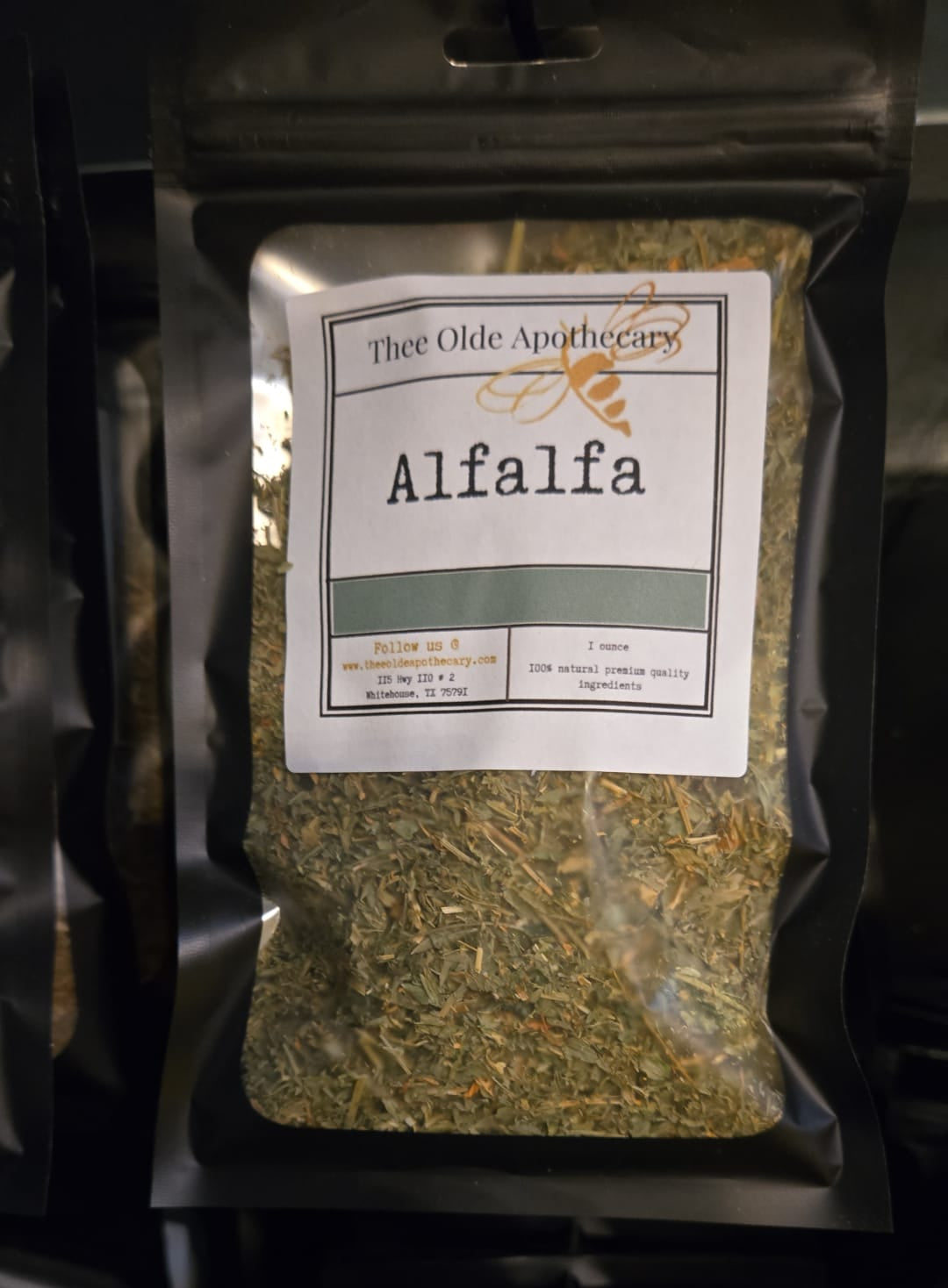 Package of alfalfa with a label on a black background