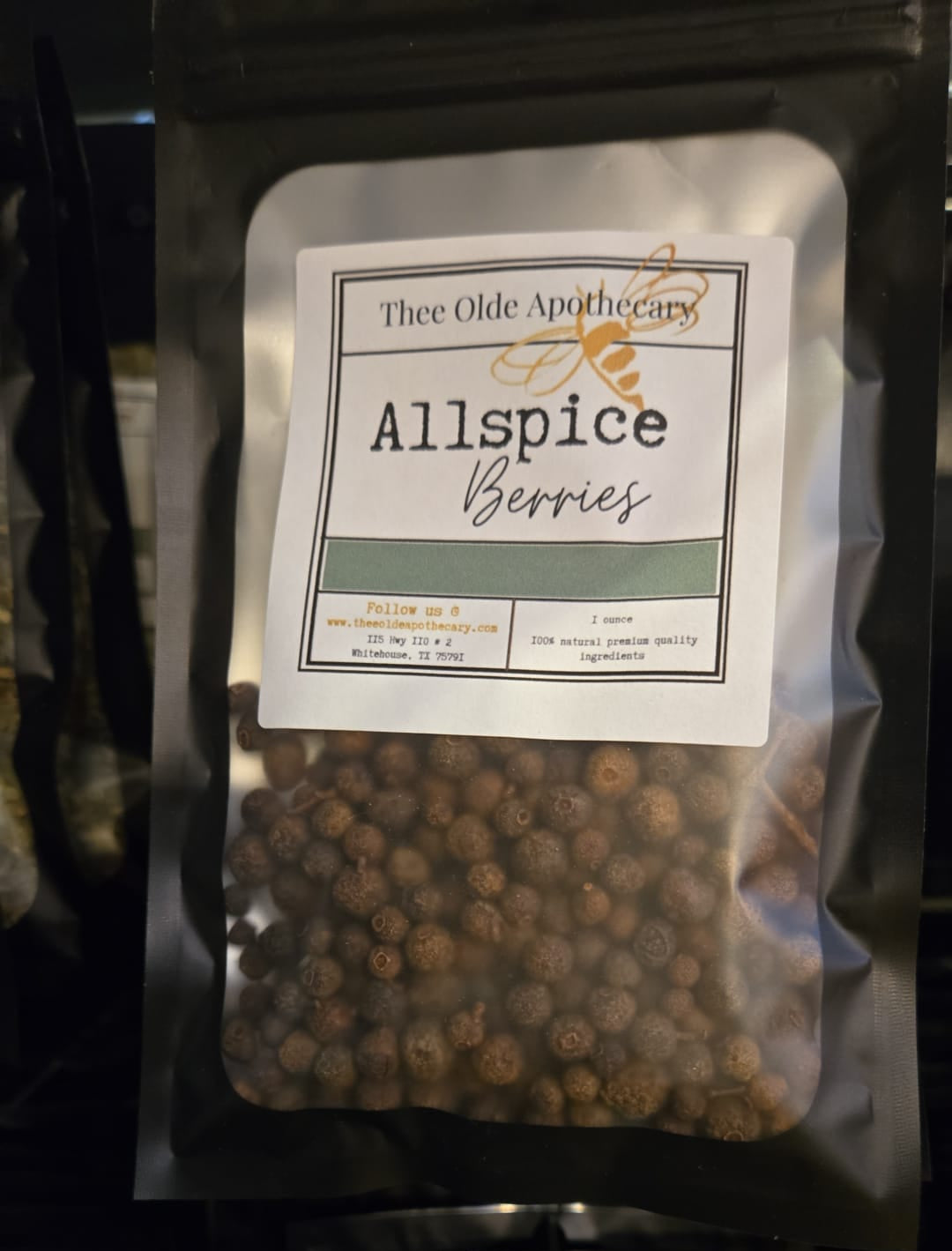 Package of Allspice Berries with a label on a black background