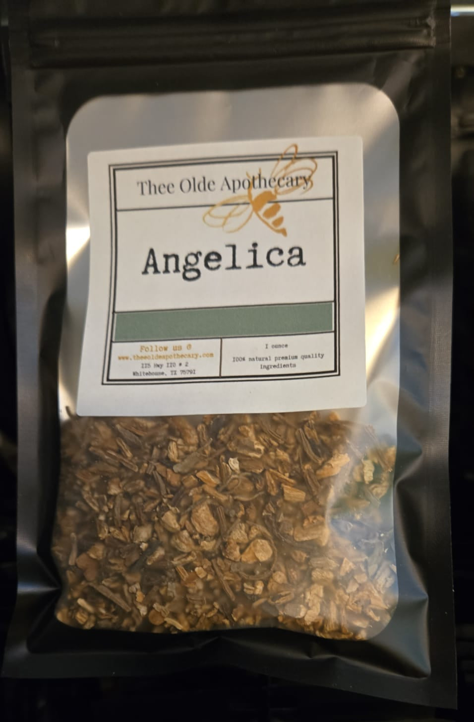 Packaged angelica from Thee Olde Apothecary on a reflective surface
